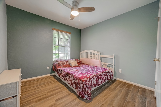 bedroom with ceiling fan and hardwood / wood-style flooring