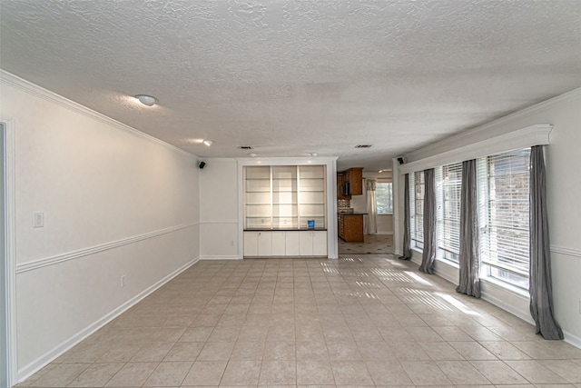 unfurnished living room with light tile patterned flooring, a textured ceiling, and crown molding