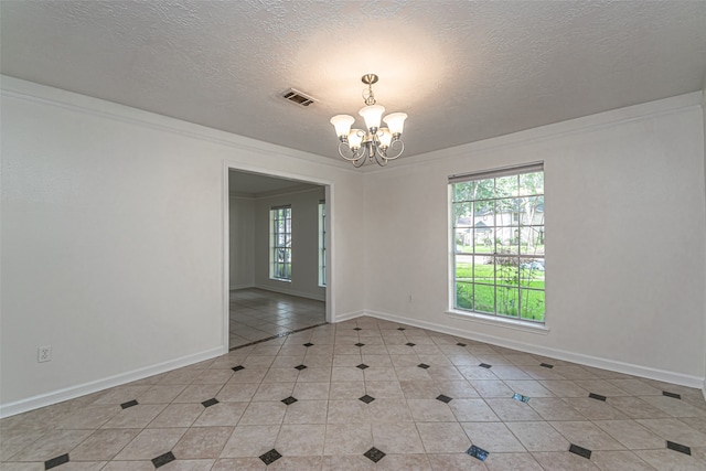 spare room featuring crown molding, a textured ceiling, a notable chandelier, and light tile patterned floors