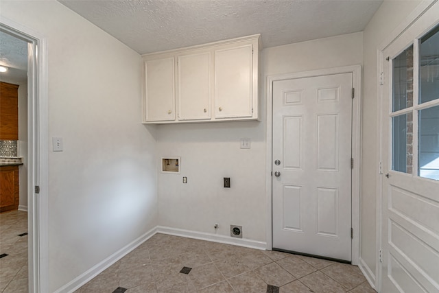 laundry area with hookup for an electric dryer, washer hookup, cabinets, and light tile patterned floors