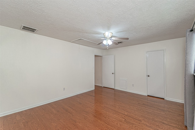 unfurnished room with ceiling fan, a textured ceiling, and hardwood / wood-style flooring