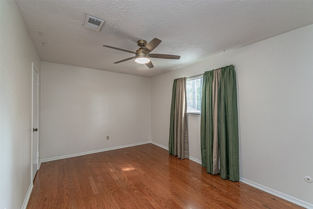 spare room with wood-type flooring, a textured ceiling, and ceiling fan