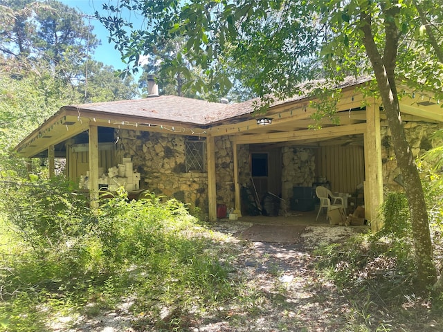 back of house featuring a garage