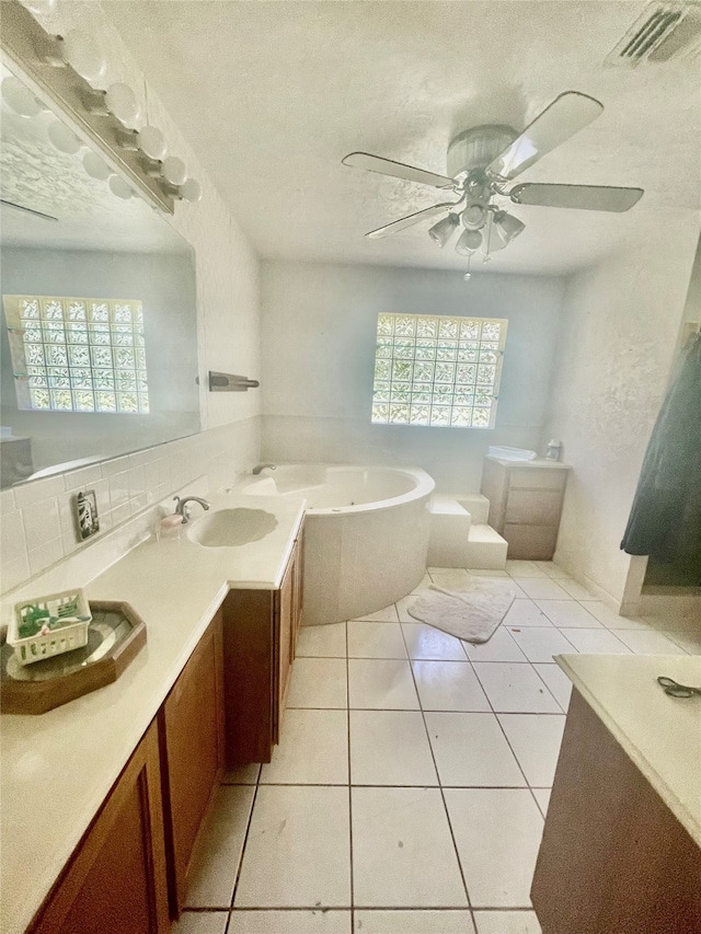 bathroom featuring a wealth of natural light, tile patterned flooring, vanity, and ceiling fan