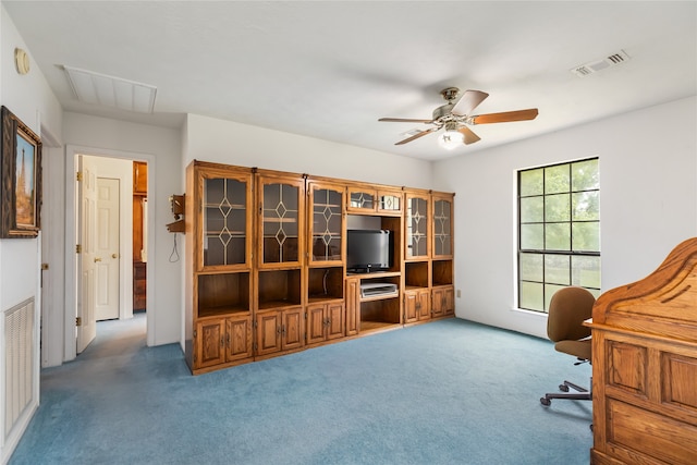 carpeted home office featuring ceiling fan