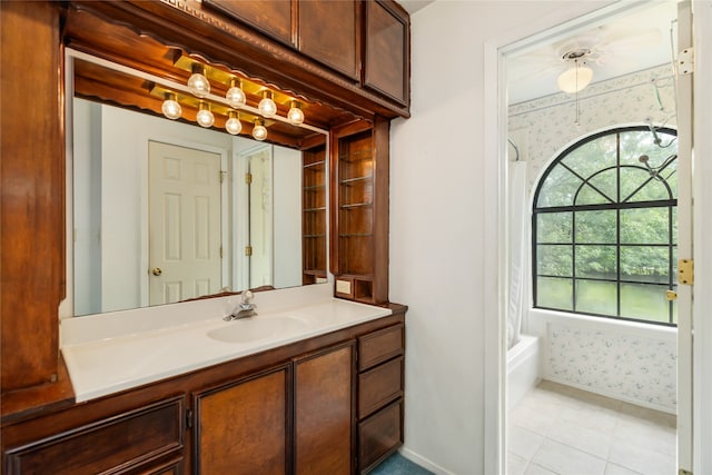 bathroom featuring vanity, shower / bathing tub combination, a wealth of natural light, and tile patterned flooring