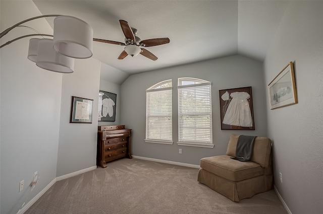 living area with light colored carpet, ceiling fan, and vaulted ceiling