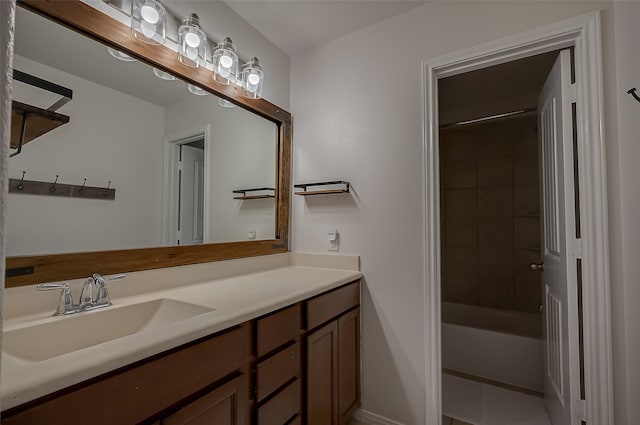 bathroom featuring tiled shower / bath combo and vanity