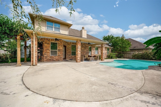 view of swimming pool featuring ceiling fan and a patio