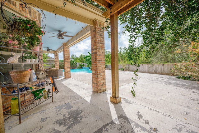 view of patio / terrace with ceiling fan and a fenced in pool