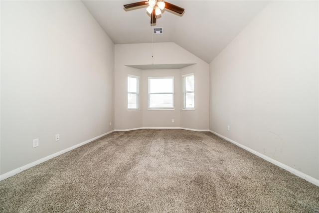 carpeted empty room with vaulted ceiling and ceiling fan