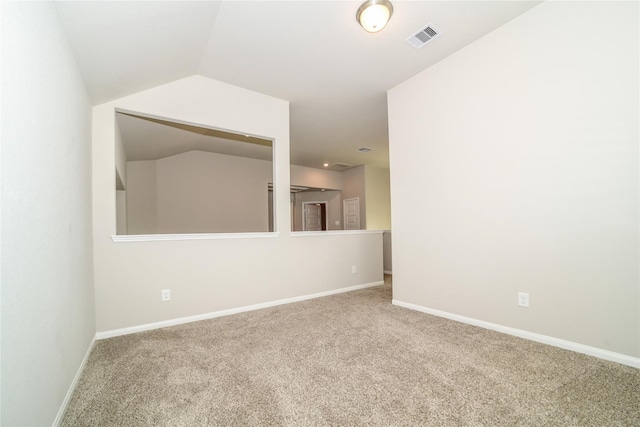 empty room featuring lofted ceiling and carpet floors