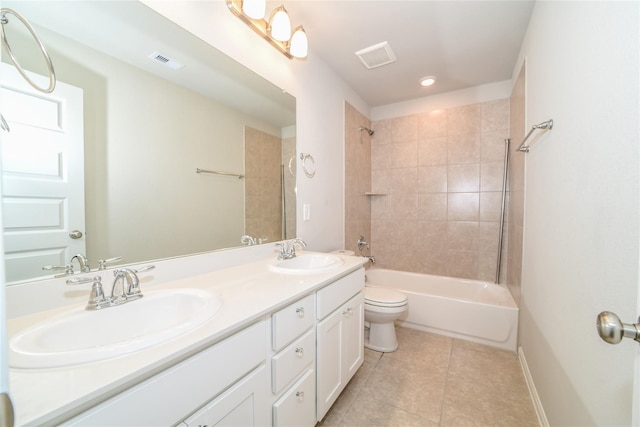 full bathroom featuring tile patterned flooring, vanity, tiled shower / bath combo, and toilet