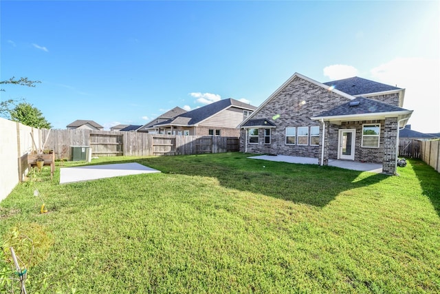 rear view of property featuring a yard and a patio area