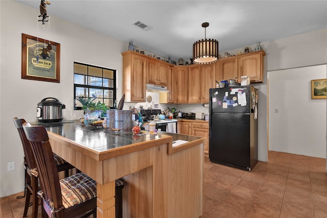 kitchen with kitchen peninsula, black fridge, white electric range, and tile counters