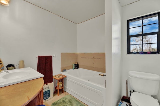 bathroom featuring toilet, a bathing tub, and vanity