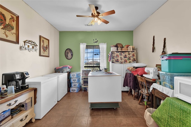 laundry room with tile patterned floors, washer and clothes dryer, and ceiling fan