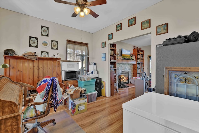 home office with light hardwood / wood-style flooring and ceiling fan