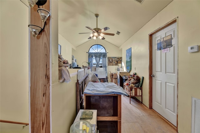 bedroom with light hardwood / wood-style flooring, ceiling fan, and lofted ceiling