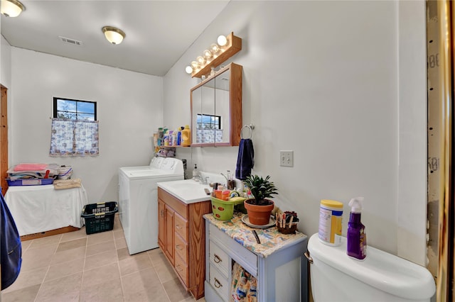 bathroom featuring vanity, separate washer and dryer, toilet, and tile patterned flooring