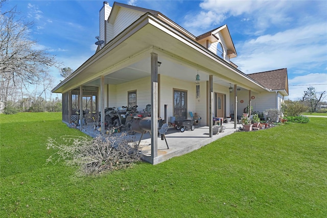 rear view of house featuring a yard