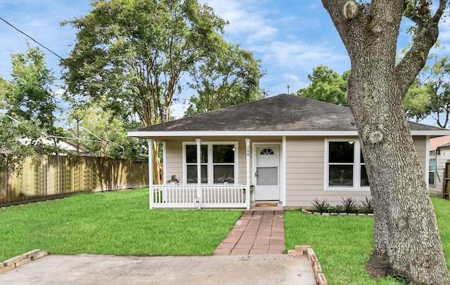 bungalow with covered porch and a front yard