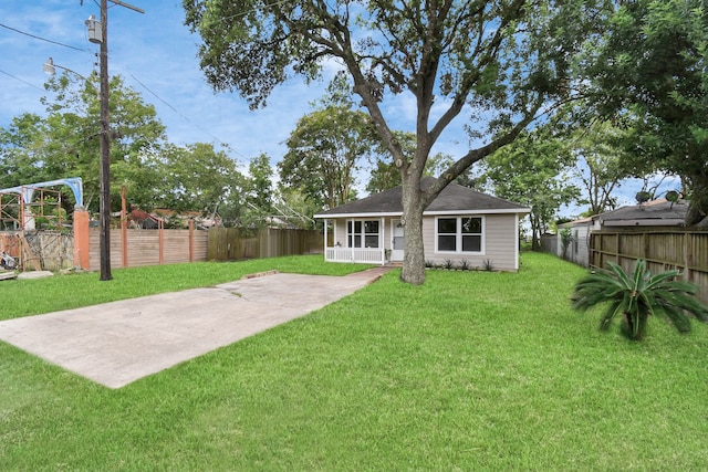 rear view of property featuring a lawn