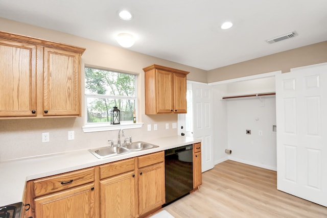 kitchen with black dishwasher, sink, and light hardwood / wood-style floors