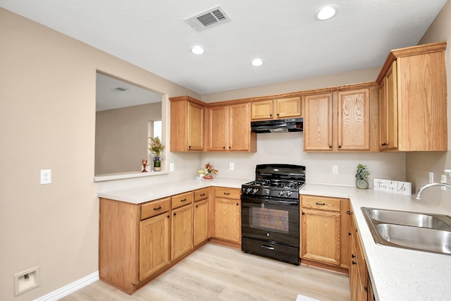 kitchen with sink, black range with gas stovetop, and light wood-type flooring