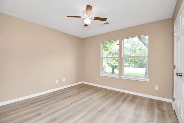 spare room featuring plenty of natural light, light wood-type flooring, and ceiling fan