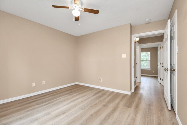 spare room featuring light wood-type flooring and ceiling fan