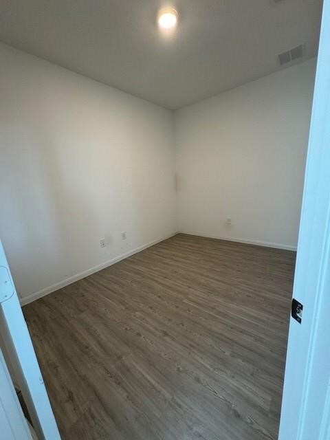 spare room featuring dark hardwood / wood-style floors