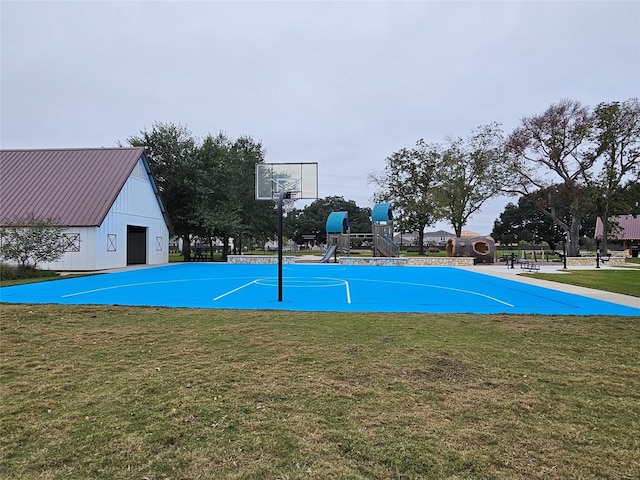 view of sport court with a playground and a lawn