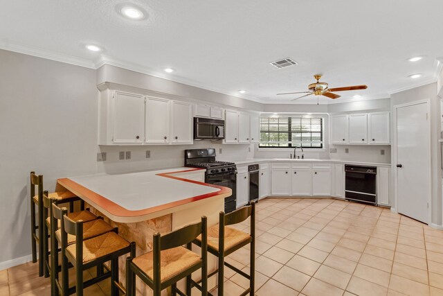 kitchen with white cabinets, black appliances, ceiling fan, and crown molding