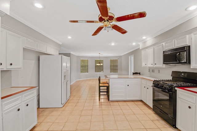 kitchen featuring a breakfast bar area, black appliances, crown molding, and light tile patterned floors