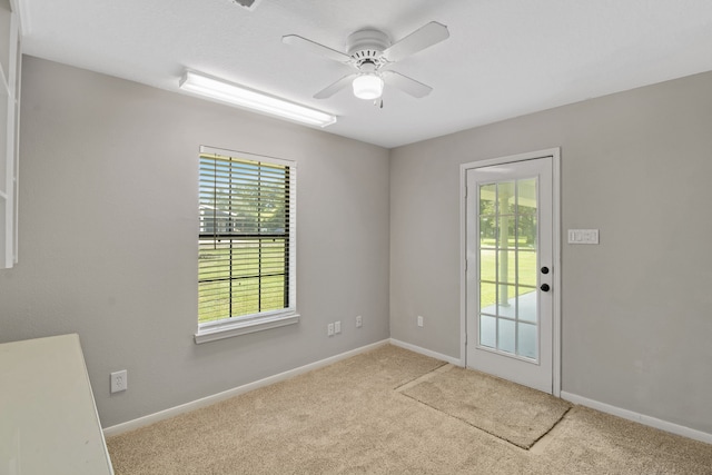 empty room featuring a healthy amount of sunlight and ceiling fan