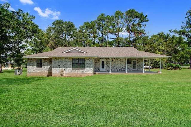 single story home featuring a front lawn, a shingled roof, and brick siding