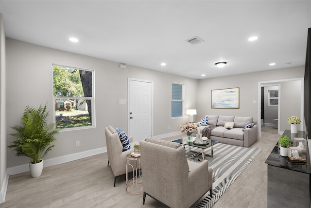 living room featuring a wealth of natural light and light hardwood / wood-style floors