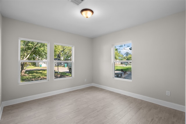 empty room with light hardwood / wood-style flooring