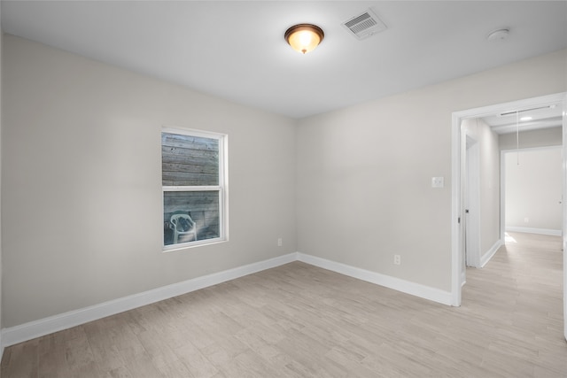 unfurnished room with light hardwood / wood-style floors