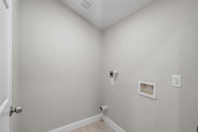 laundry room featuring hookup for an electric dryer, light hardwood / wood-style flooring, and washer hookup