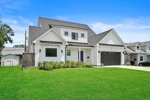 modern inspired farmhouse featuring a garage and a front yard