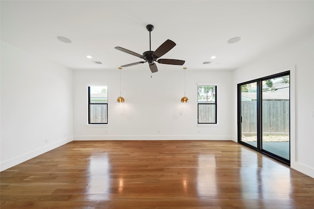 unfurnished room featuring hardwood / wood-style floors and ceiling fan