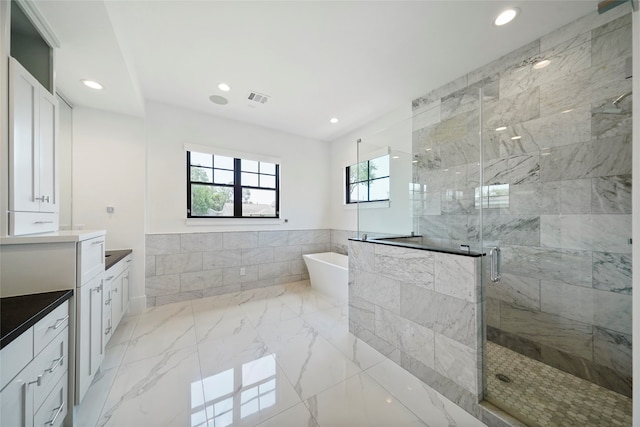 bathroom featuring independent shower and bath and vanity