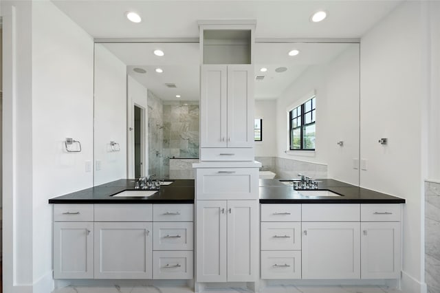 bathroom featuring vanity and a shower with shower door