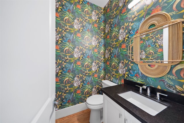 bathroom with vanity, hardwood / wood-style floors, and toilet