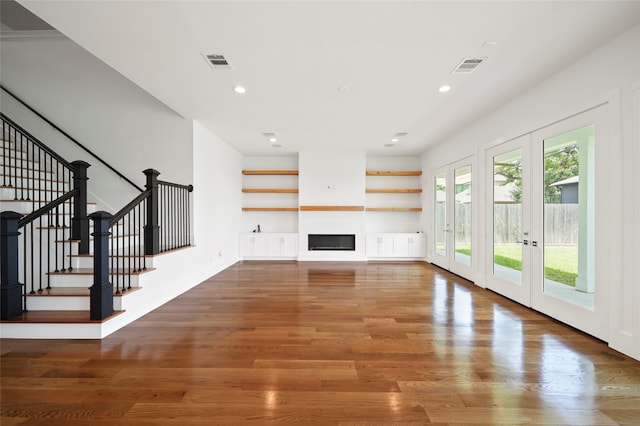 unfurnished living room with french doors and dark wood-type flooring