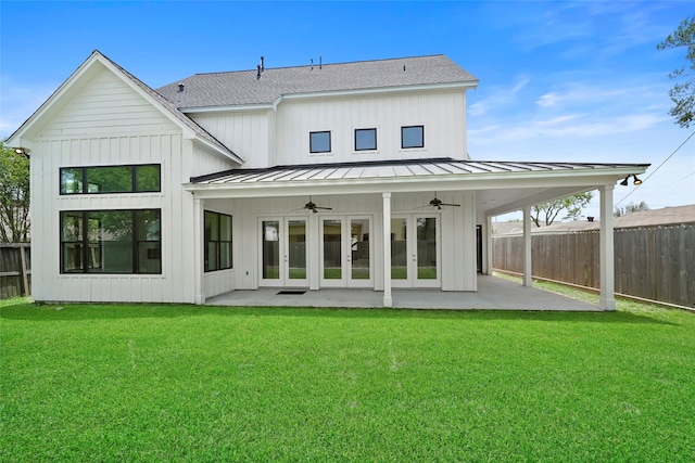 rear view of property with ceiling fan, a patio area, and a yard