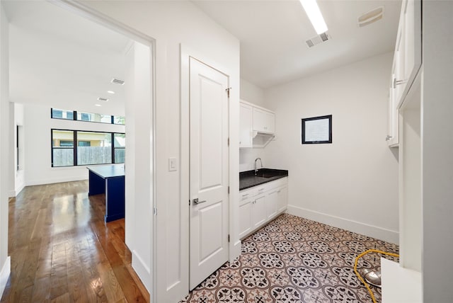 washroom featuring light wood-type flooring and sink