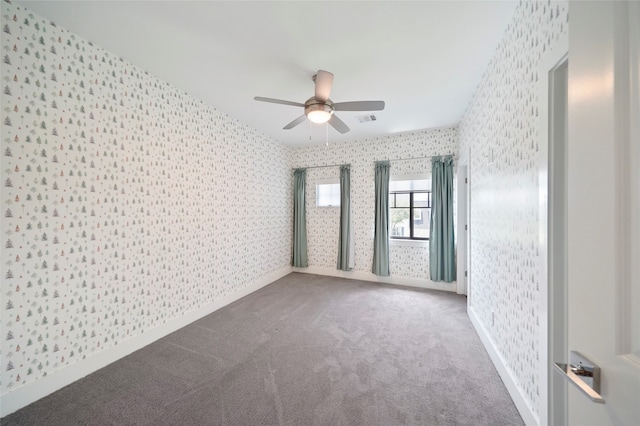 carpeted spare room with ceiling fan